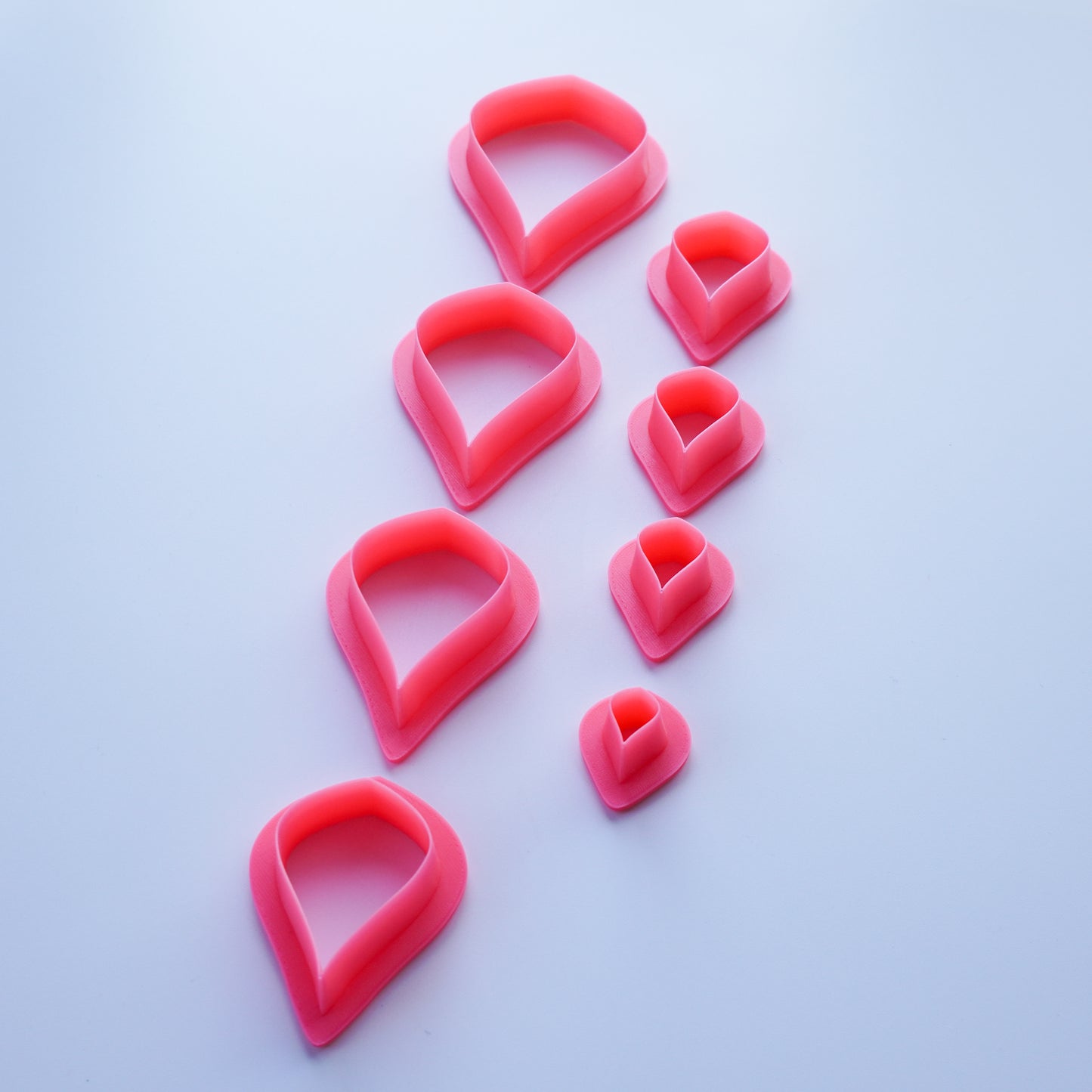 Pink Pear shaped clay cutters shown in descending sizes from 2.50 inch to 0.50 inch.