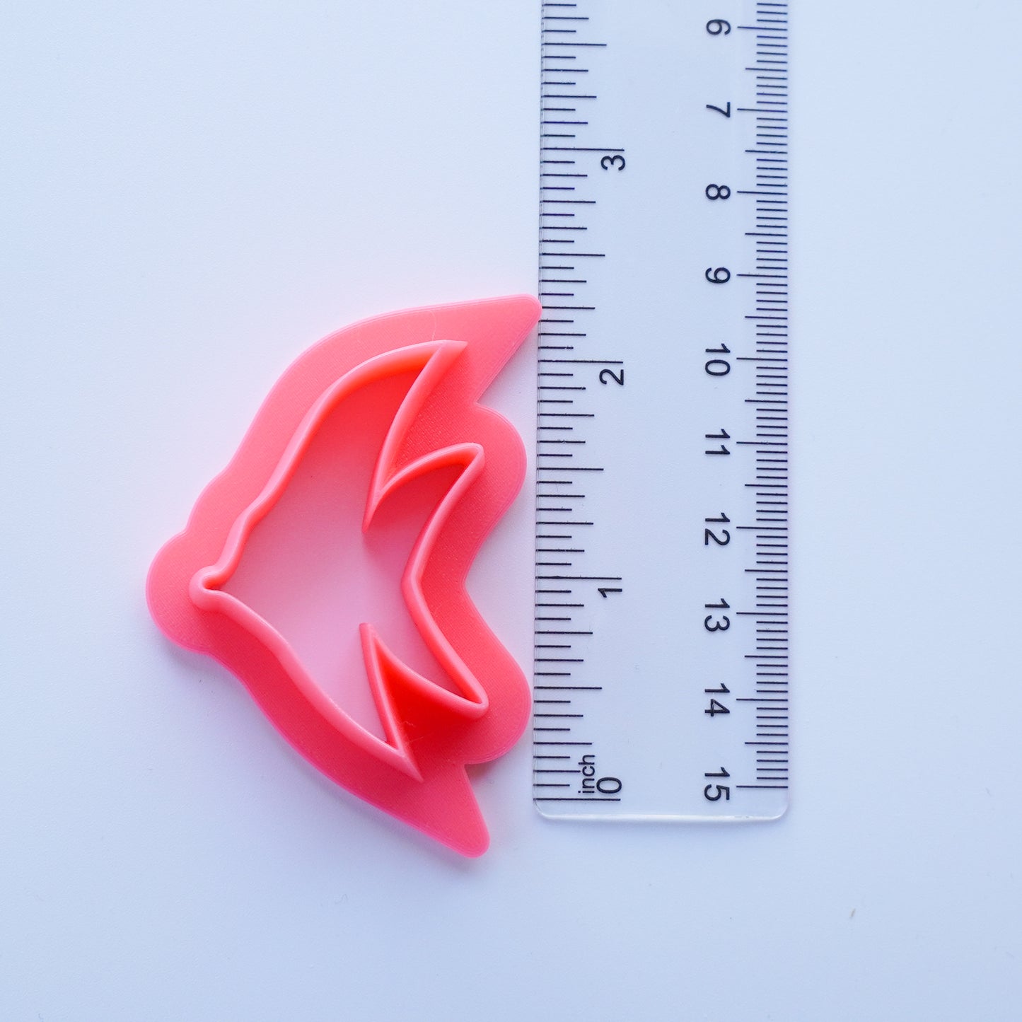 Pink Tropical Fish Clay Cutter is shown next to a ruler that measures the cutter as 2.00 inches.