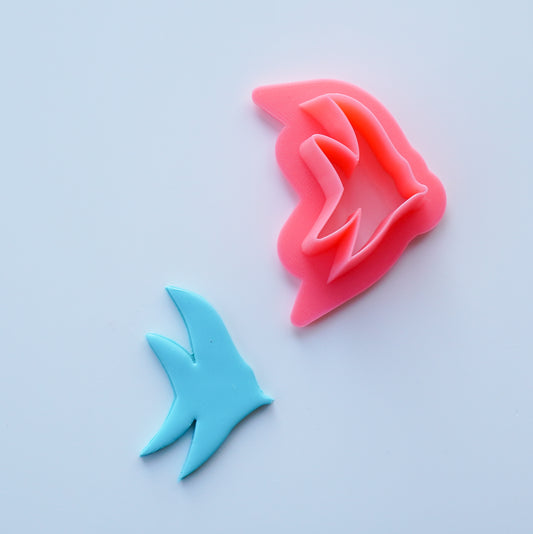 Pink Tropical Fish Clay Cutter is shown above a blue cut sample of polymer clay.